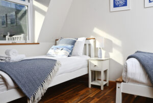 Bedroom No 3 with twin beds and a cliff view